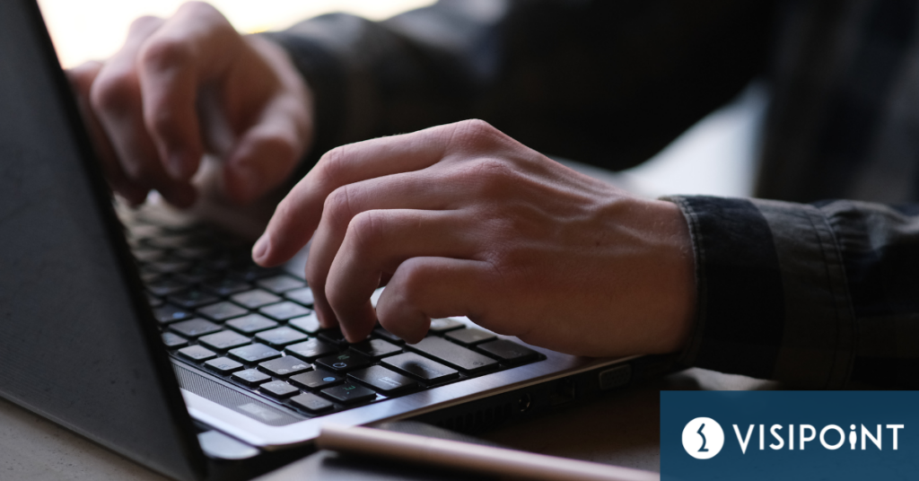 Hands typing on a laptop keyboard